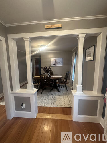 A dining room with a table and chairs.