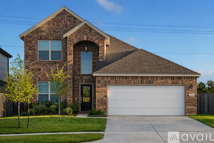 A house with a brick facade and a large garage door.