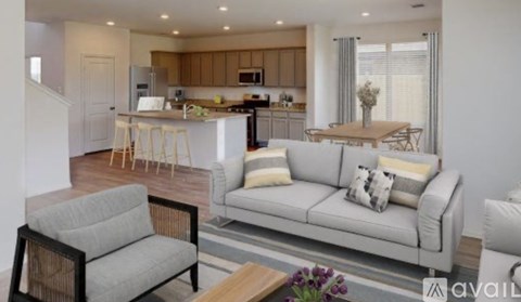 A modern living room with a grey sofa and a wooden coffee table.