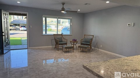 A living room with a table and chairs is available for rent.