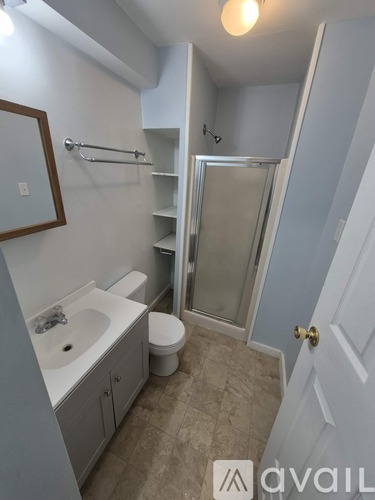 A bathroom with a sink, toilet, and shower.