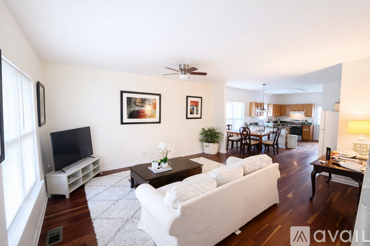 A living room with a white couch and a television.