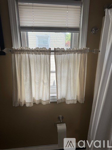 A white washing machine with a door open.