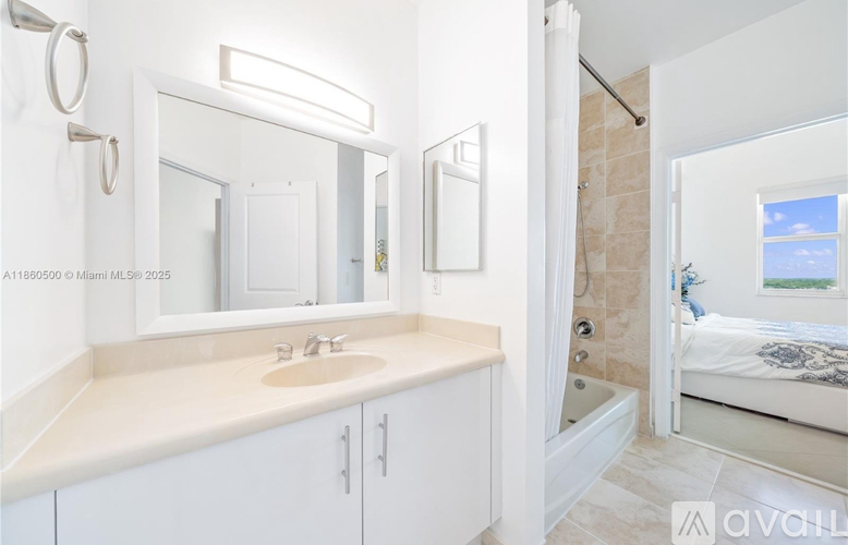 A bathroom with a sink, mirror, and a bedroom in the background.