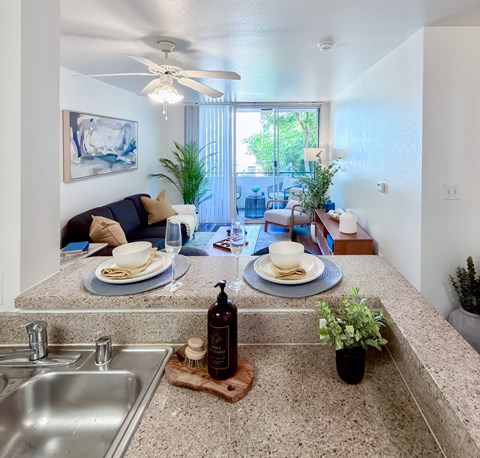 A kitchen with a dining table set for two.