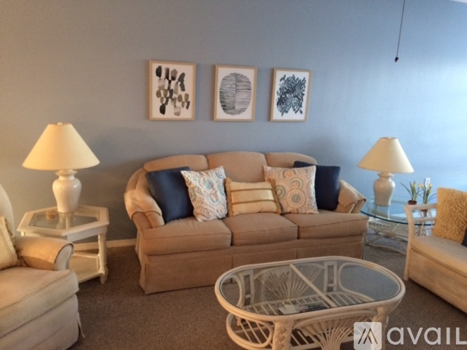 A living room with a sofa, two lamps, and a coffee table.