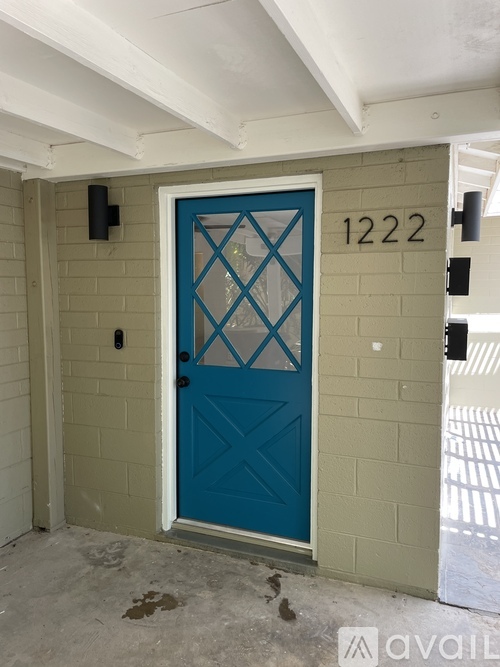A blue door with a diamond pattern in the middle is numbered 1222.