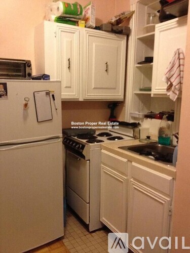 A kitchen with white appliances and cabinets is shown.