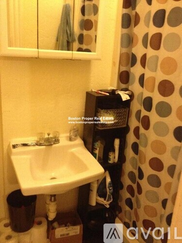 A bathroom with a sink and a mirror.