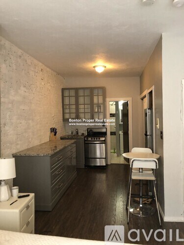 A kitchen with a counter top and a stove top oven.