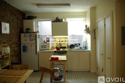 A kitchen with a refrigerator, stove, and sink.