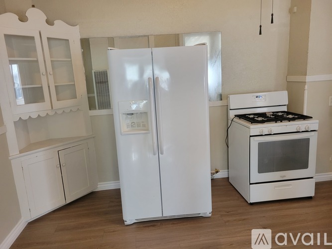 A white refrigerator and oven in a kitchen.