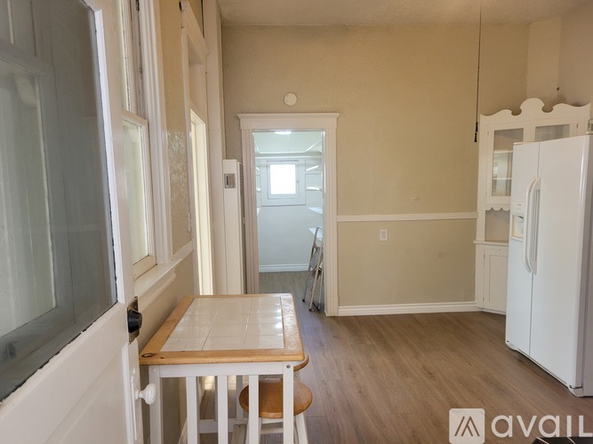 A kitchen with a table and chairs in the middle of the room.