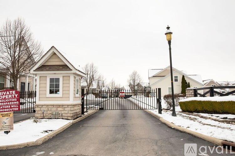 A gated entrance to a private property with a sign stating "Private Property Soliciting Will Be Prosecuted".