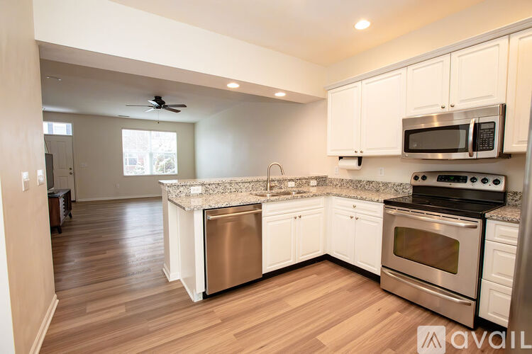 A kitchen with white cabinets and stainless steel appliances.