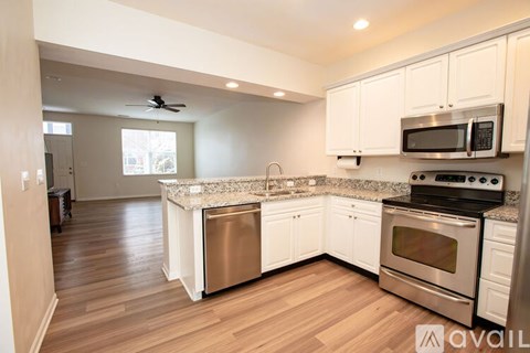 A kitchen with white cabinets and stainless steel appliances.