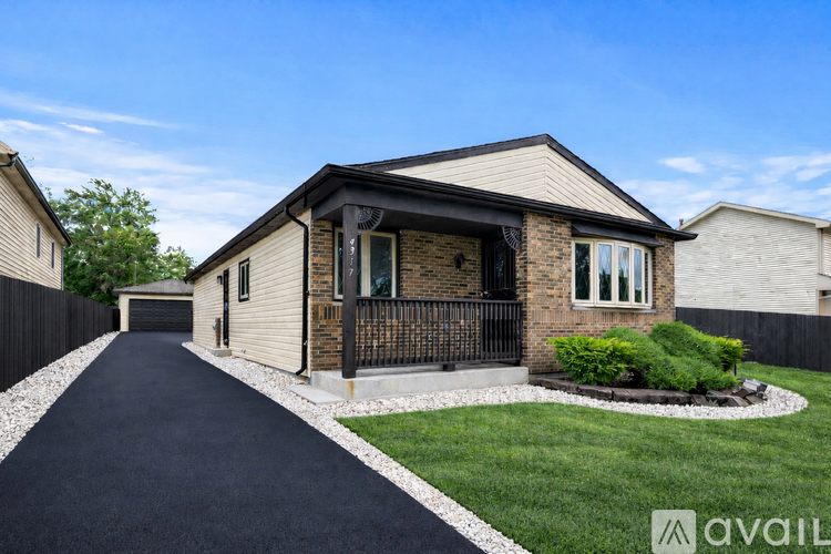 A house with a driveway in front of it.