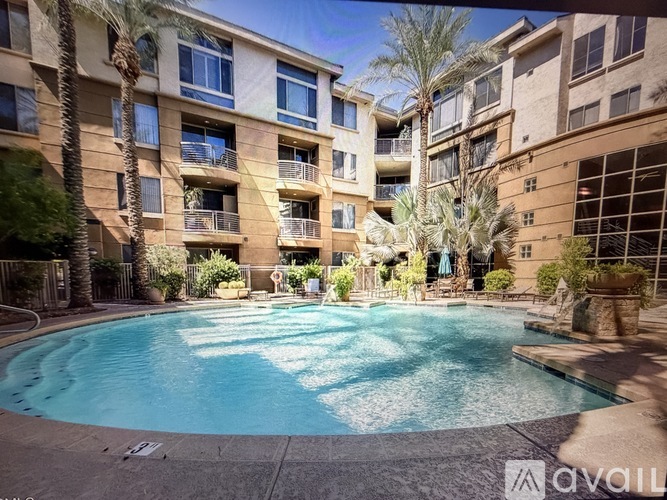 A swimming pool in front of apartment buildings.