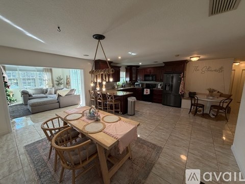 A dining room with a wooden table set for four.