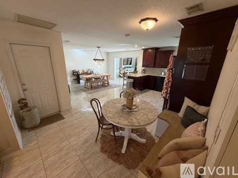 A living room with a dining table and chairs.