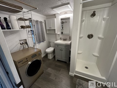 A small bathroom with a washer and dryer in it.