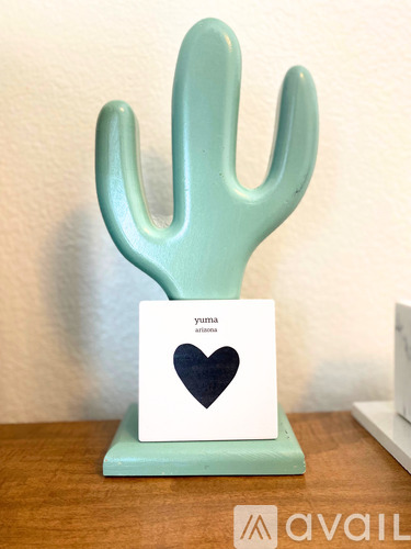A cactus shaped object with a card that has a heart on it.