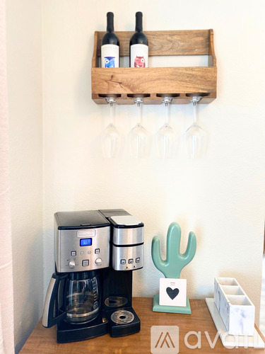 A coffee machine and a cactus are on a table.