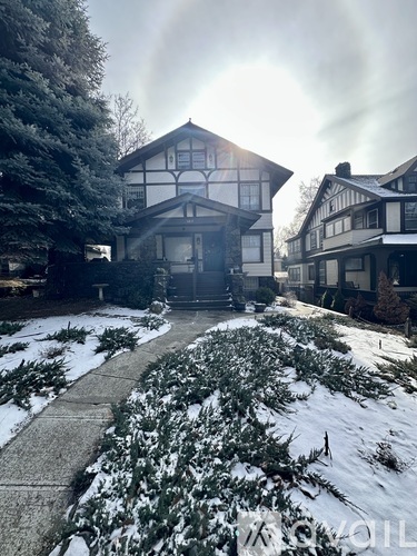 A house with a snowy front yard.