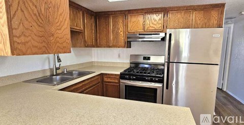 A kitchen with wooden cabinets and stainless steel appliances.