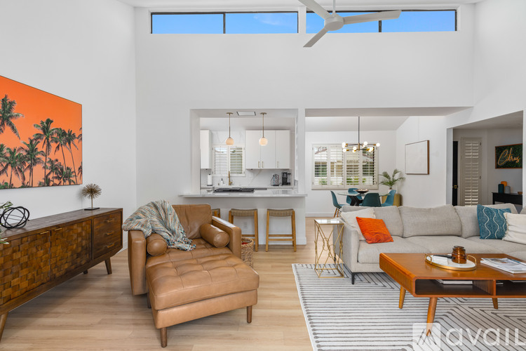 A living room with a brown leather chair and a brown wooden coffee table.