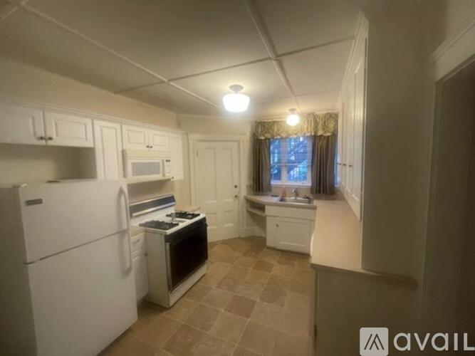 A kitchen with a refrigerator, stove, and oven.