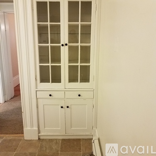 A white wooden door with glass panels and two drawers below it.