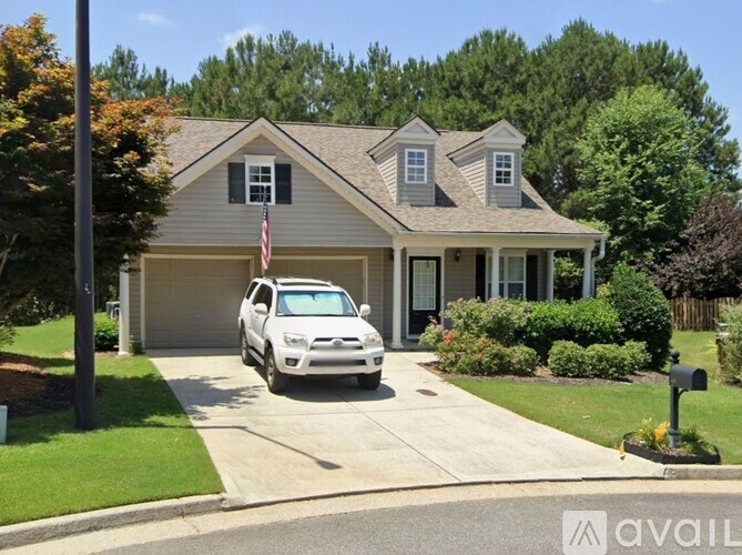 A house with a car parked in front of it.