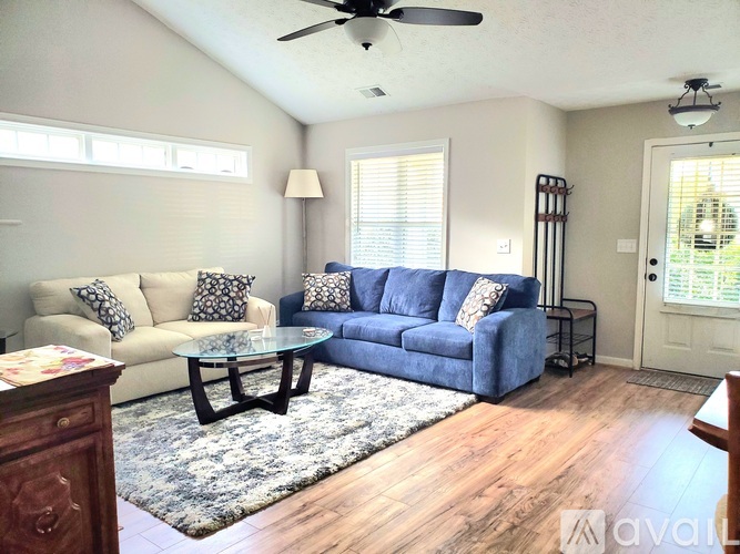 A living room with a blue couch and a coffee table.