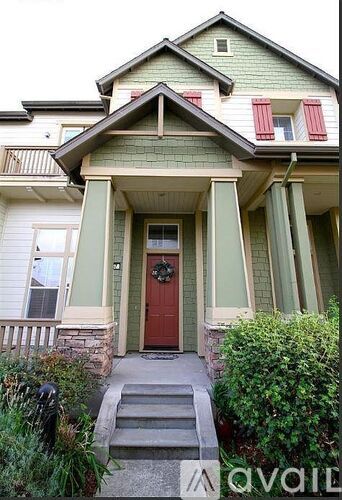 A house with a green front and a red door.