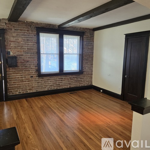 A kitchen with wooden cabinets and black appliances.