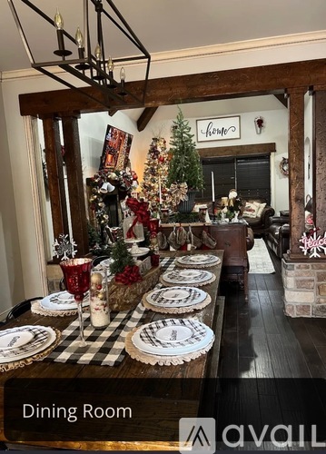 A dining room with a Christmas tree and decorations.