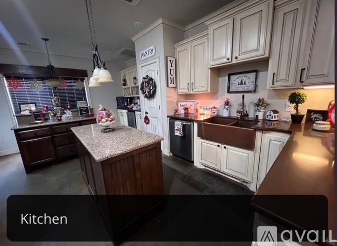 A kitchen with a granite countertop and a wreath on the door.