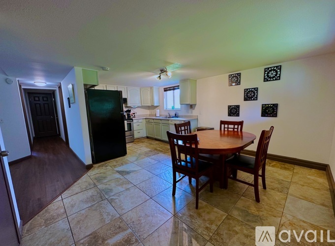 A kitchen with a table and chairs in the middle of the room.