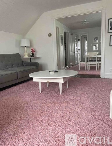 A living room with a grey couch and a white coffee table.