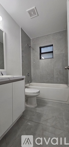 A bathroom with a toilet, sink, and bathtub.