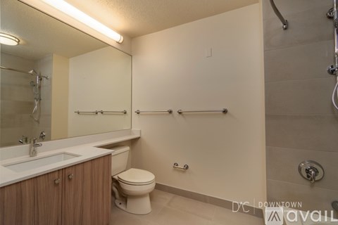 A bathroom with a toilet, sink, and shower.