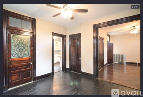 A room with a wooden floor and a ceiling fan.