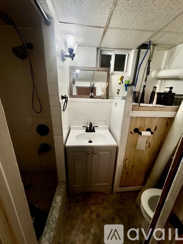 A kitchen with wooden floors and a washing machine in the corner.