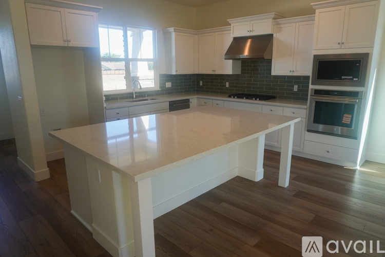 A kitchen with a large island in the middle.