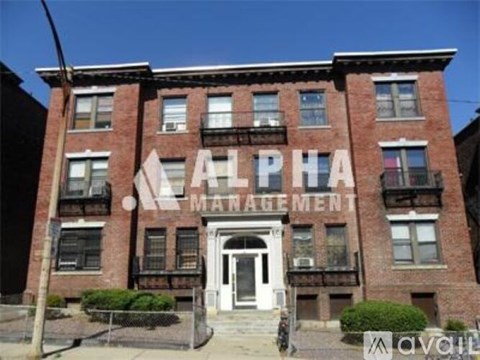 A red brick building with the words "Alpha Management" written on it.