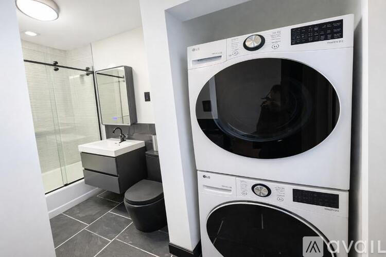 A white front loading washing machine in a laundry room.