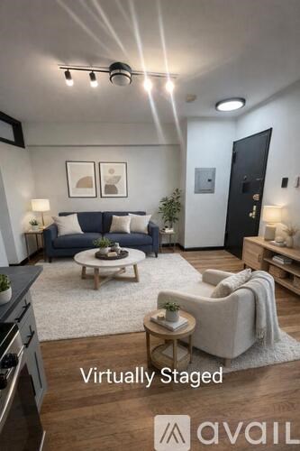 A modern living room with a blue sofa and a coffee table.
