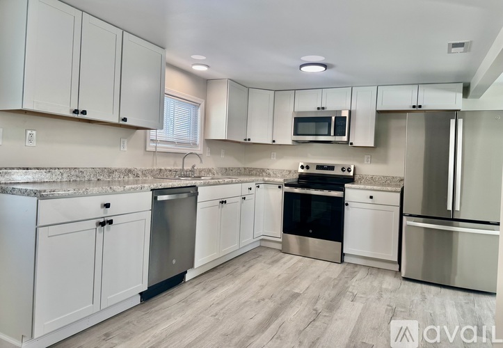 A kitchen with white cabinets and stainless steel appliances.