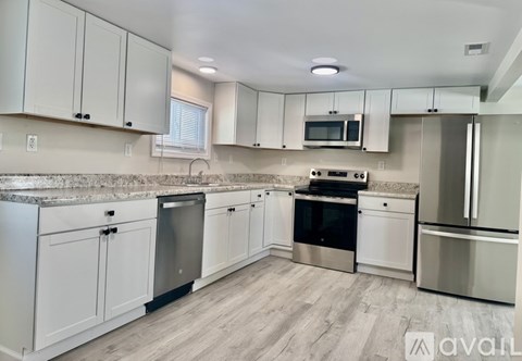 A kitchen with white cabinets and stainless steel appliances.